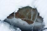 Rock Under Frozen Lake